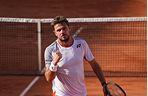 Stan Wawrinka at the net on a clay court