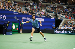 Stan Wawrinka stretching for a forehand on a stadium hard court